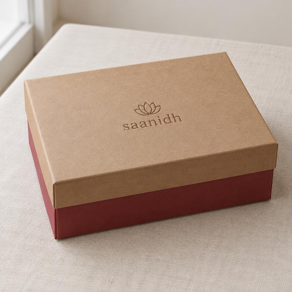 Closed Saanidh kit box on ivory linen (packaging mockup)